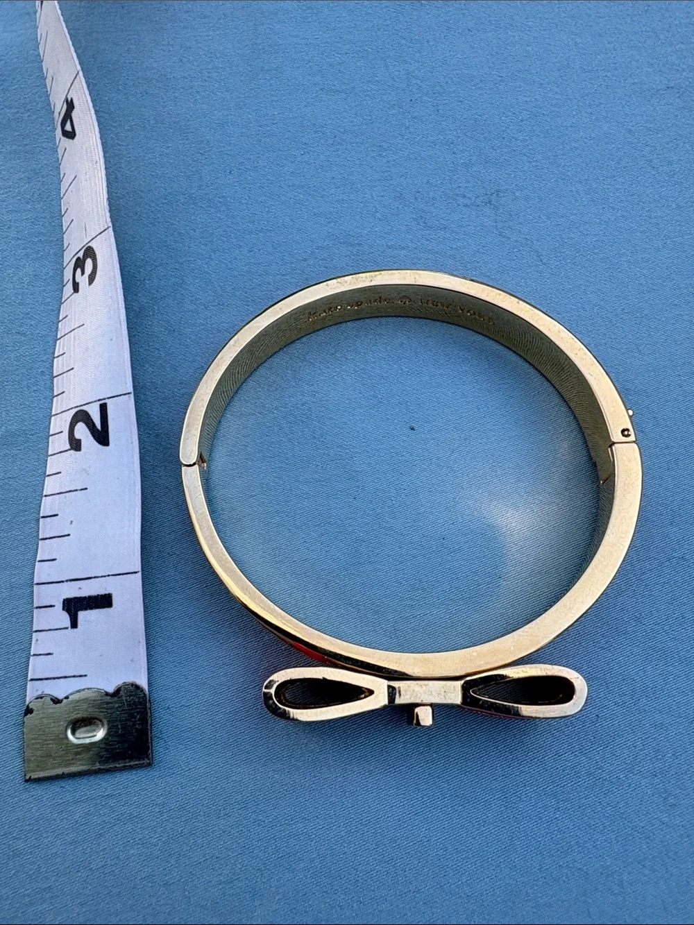 kate spade gold-tone bangle with pink enamel bow